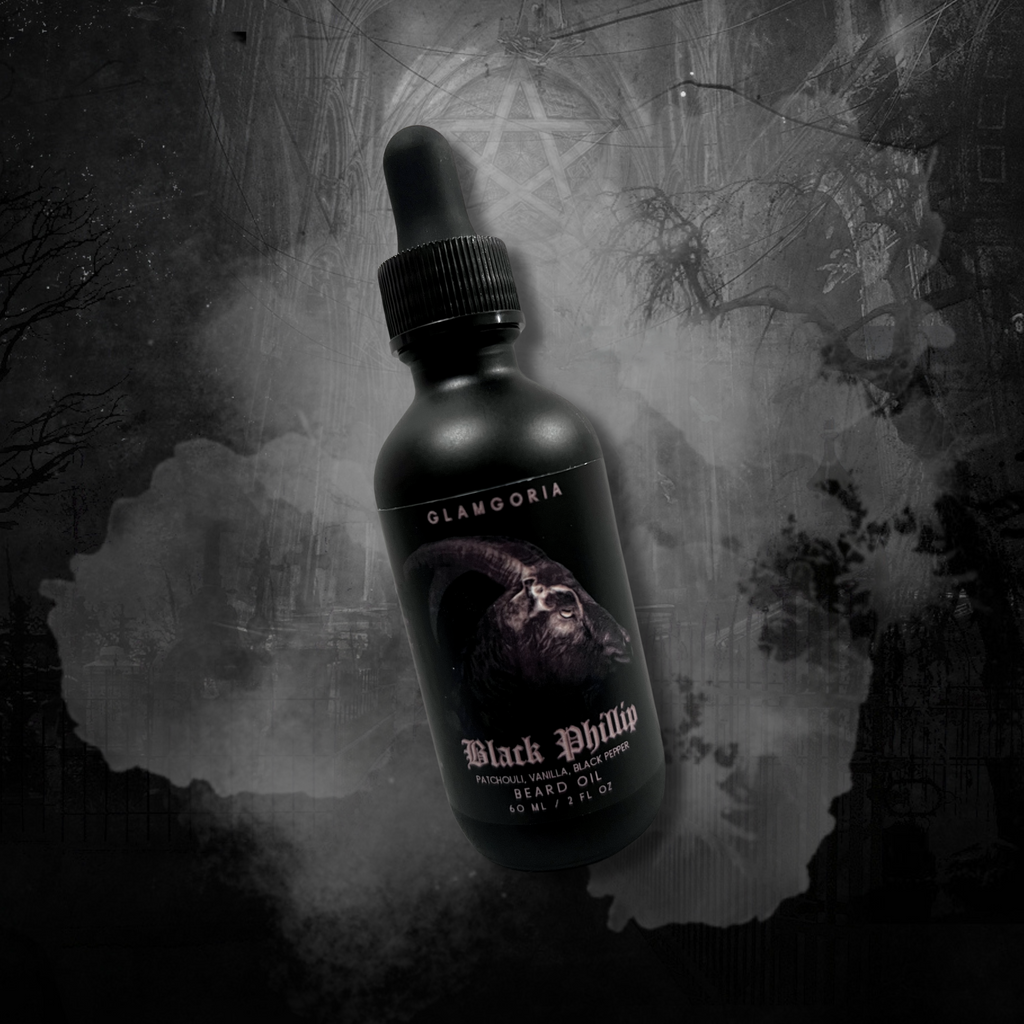 Dropper bottle of beard oil with Black Phillip artwork, nestled among dried herbs and bones. A ritualistic grooming essential.
