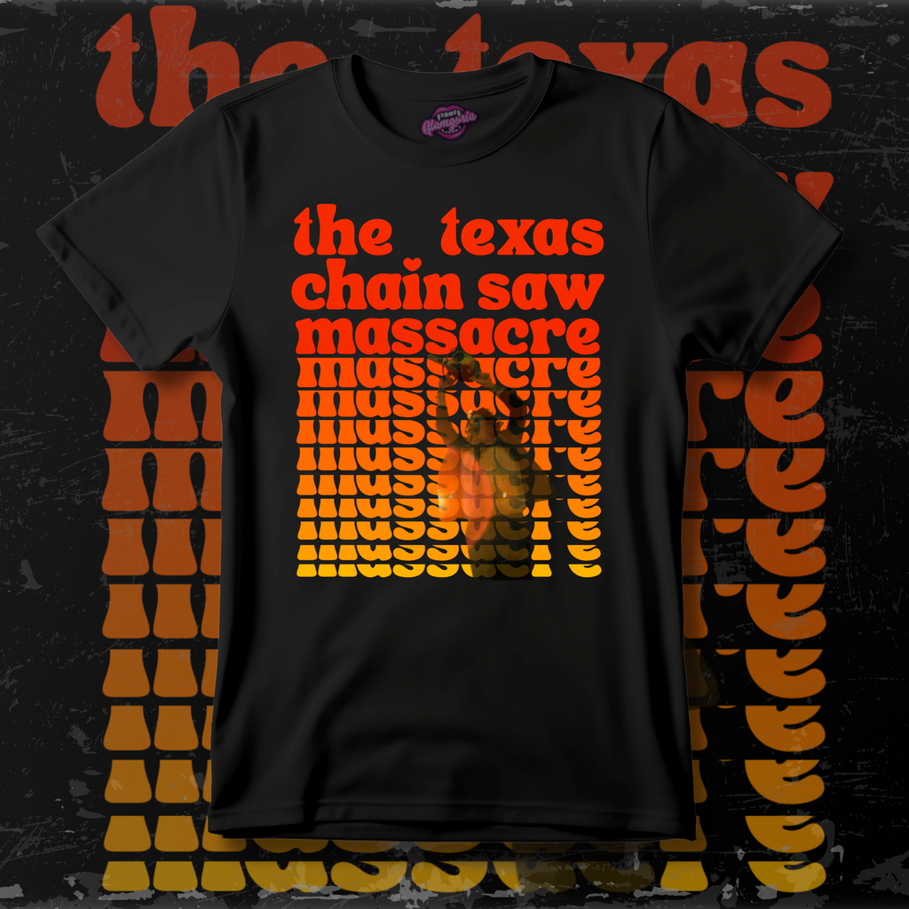 Black T-shirt with bold retro orange and yellow text reading “The Texas Chain Saw Massacre,” featuring a graphic of Leatherface swinging a chainsaw in the center.