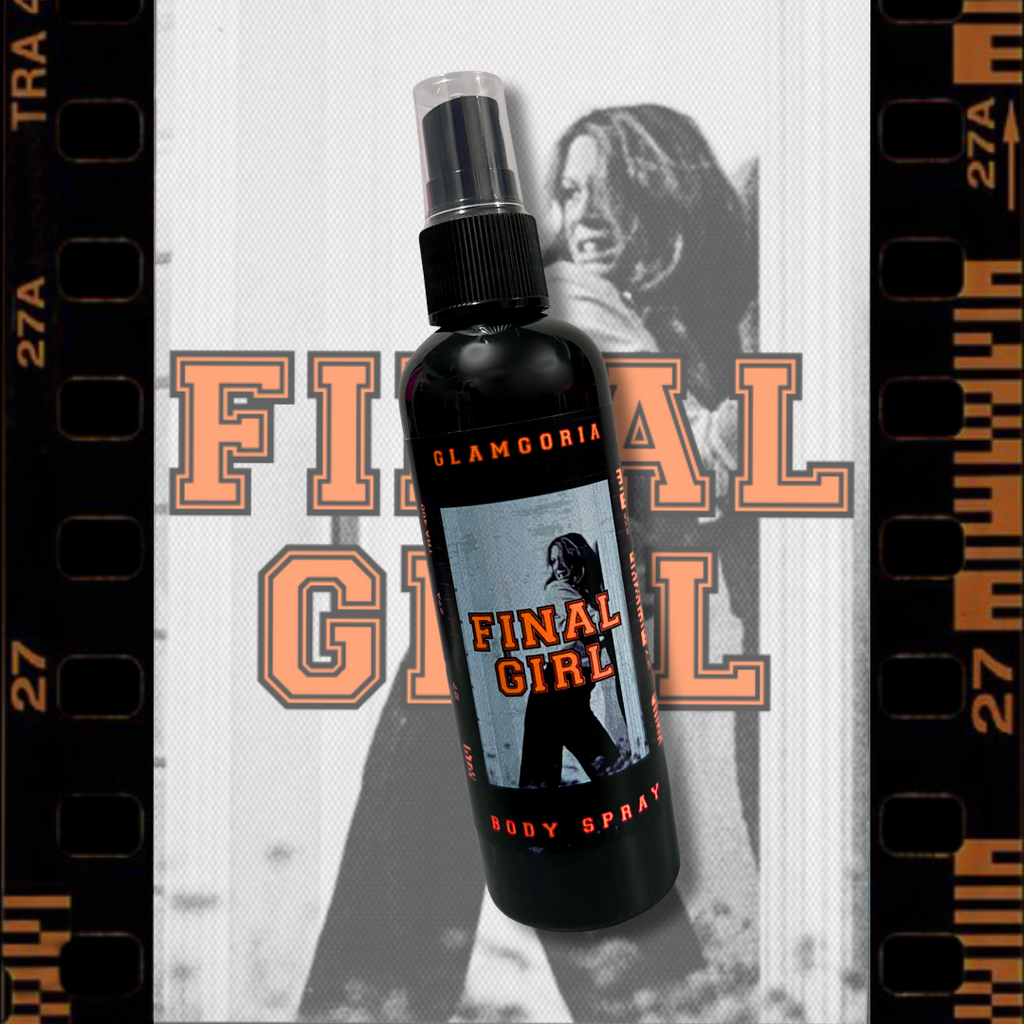 Black spray bottle of Glamgoria Final Girl Body Spray with a horror film-inspired label, featuring orange lettering and distressed retro design.