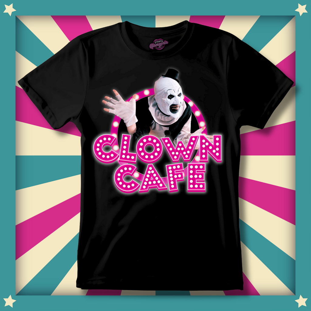  A black unisex T-shirt featuring Art the Clown from Terrifier 2 inside a neon pink circus-style marquee circle with the words “Clown Café” in bold glowing letters.