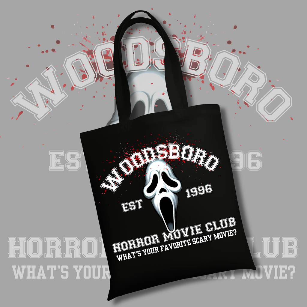 Black tote bag with the Ghostface mask design and red splatter background. Text reads “Woodsboro Est 1996 – Horror Movie Club – What’s your favorite scary movie?”