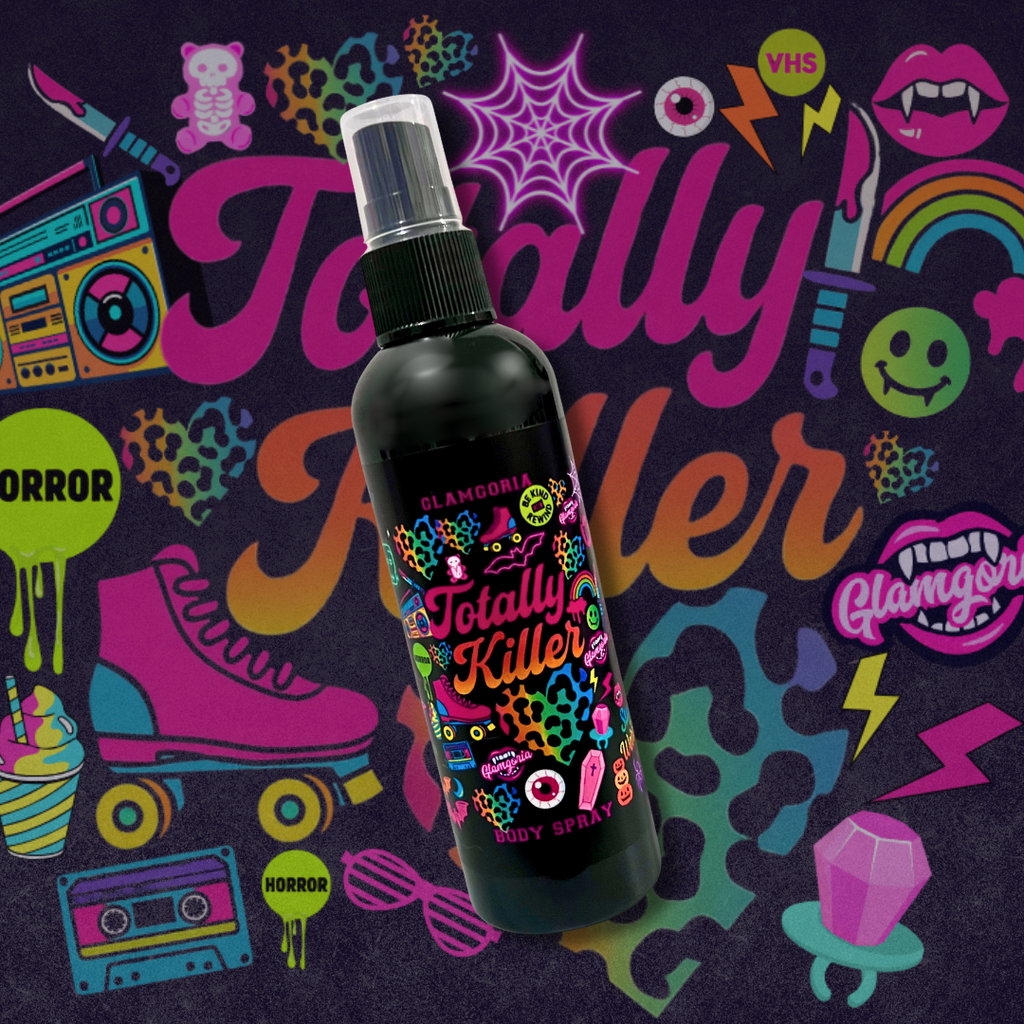 Neon-accented black spray bottle of Glamgoria Totally Killer Body Spray with horror-glam sticker illustrations. Peony, passion fruit, and blood orange scent.