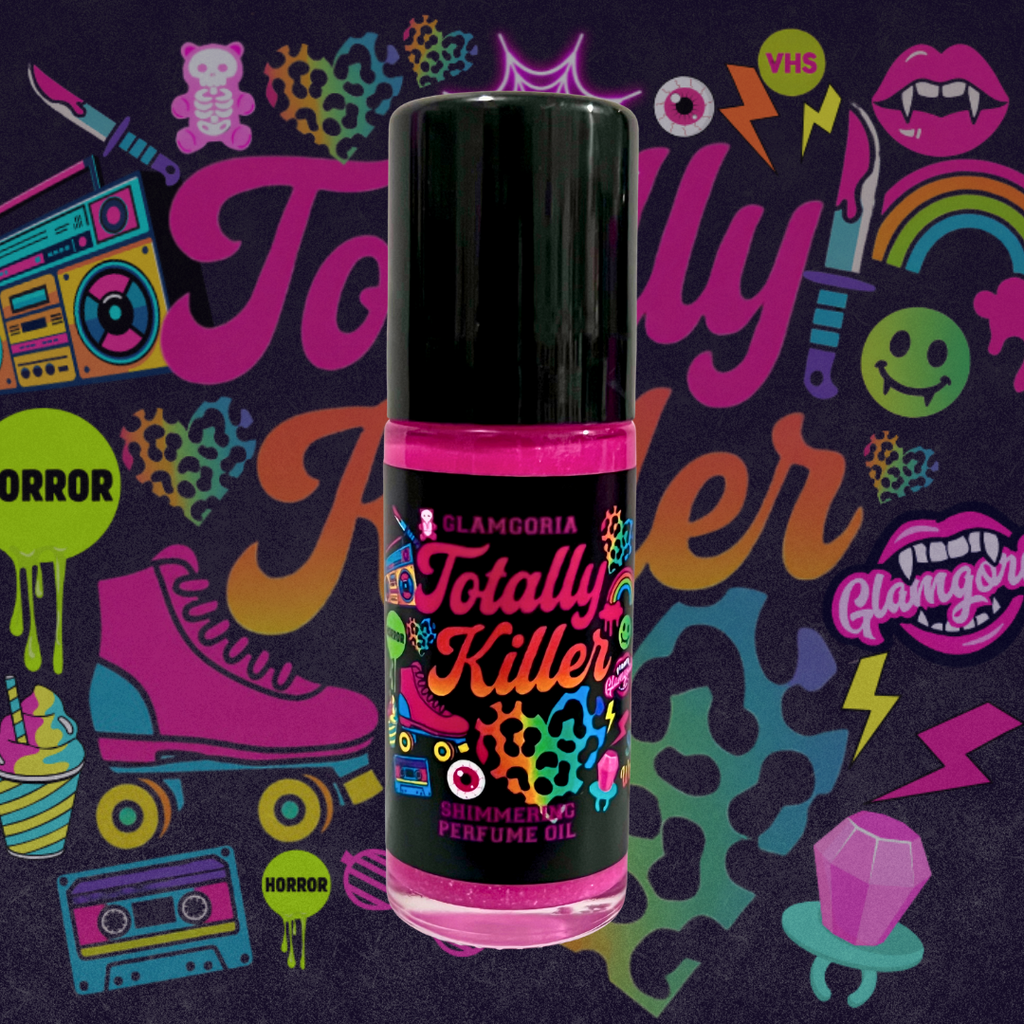 Hot pink shimmering roller bottle of Glamgoria Totally Killer Perfume Oil, featuring neon horror sticker artwork. Scented with peony, passion fruit, and blood orange.
