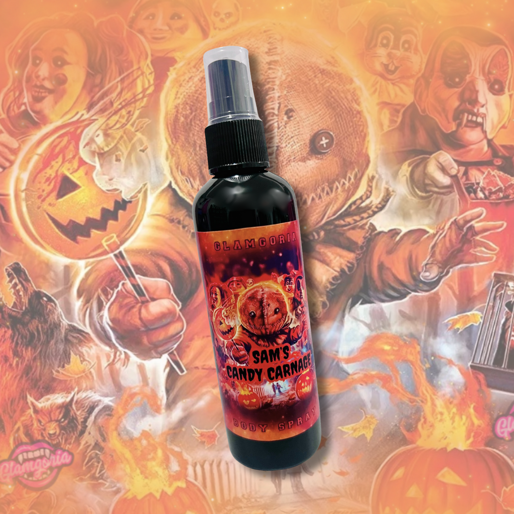 Spray bottle of Glamgoria’s Sam’s Candy Carnage Body Spray with Trick ’r Treat Sam label and fiery orange Halloween artwork.