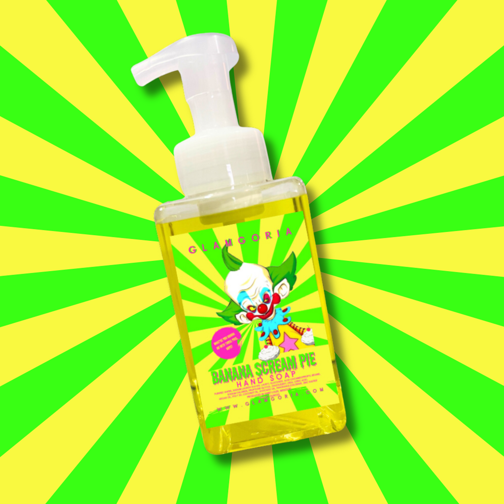 Neon yellow hand soap bottle labeled Banana Scream Pie with clown imagery and banana pie design.