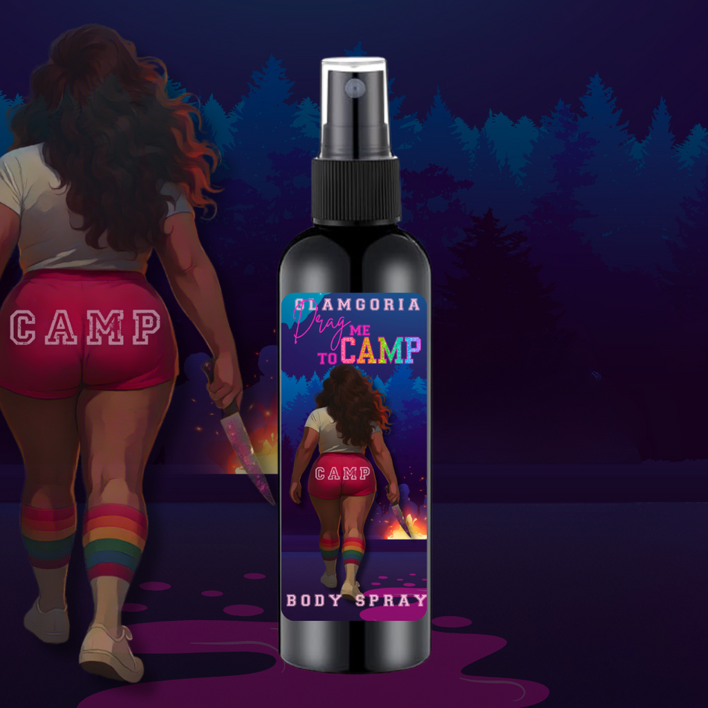 A black bottle of Glamgoria’s Drag Me to Camp body spray featuring a label with a curvy figure in rainbow knee socks and “CAMP” shorts holding a knife, walking toward a glowing campfire in the woods. The label has colorful retro text and a spooky summer camp setting.
