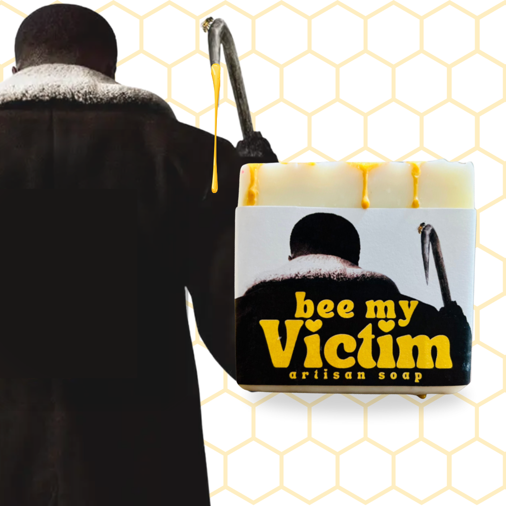 Handmade artisan soap bar with honey drip detail labeled “Bee My Victim” inspired by classic horror film imagery

