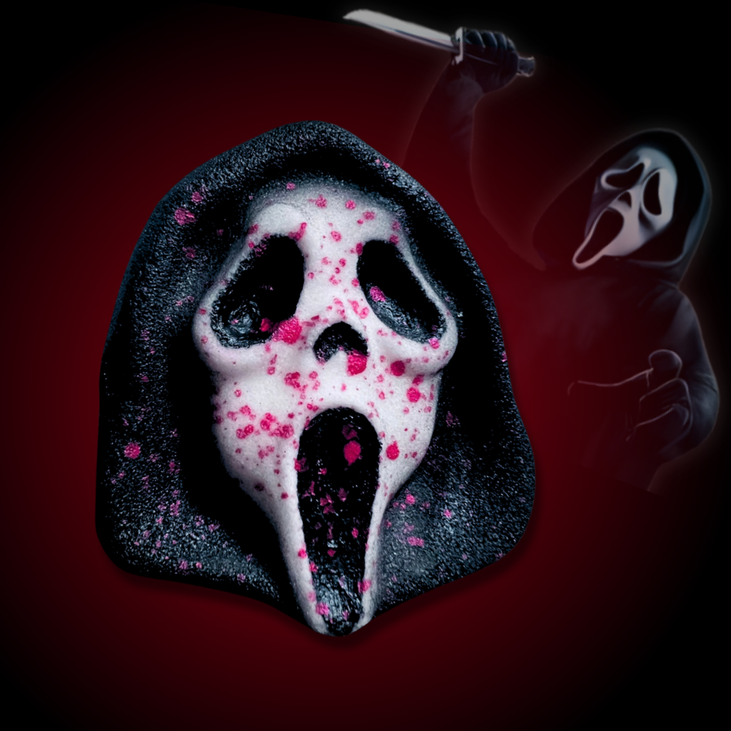 Black bath bomb shaped like a ghostface-inspired mask with red splatter details.