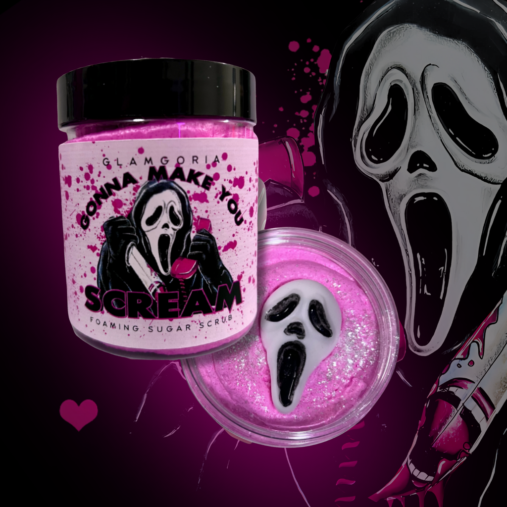 Pink foaming sugar scrub in a clear jar topped with a ghostface-inspired soap embed, labeled “Gonna Make You Scream” with pink splatter details.


