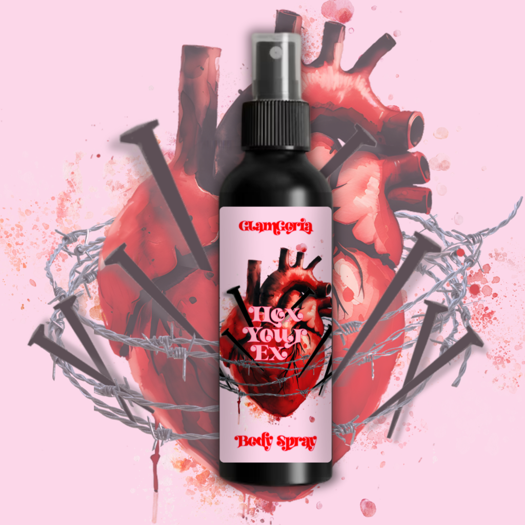 Hex Your Ex body spray in a black bottle with a spray top, featuring a pink label with an anatomical heart wrapped in barbed wire and nails on a pink background.
