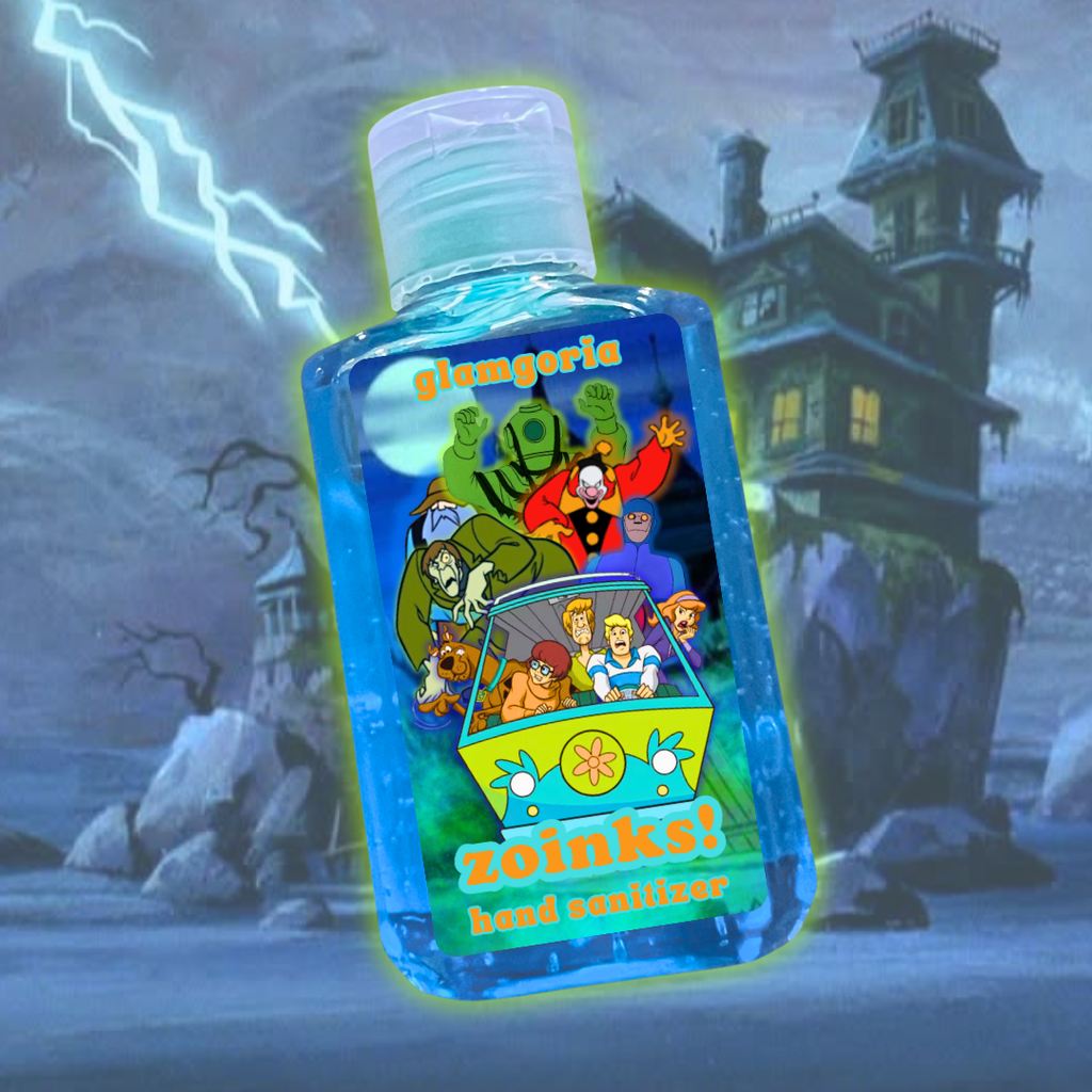 A blue hand sanitizer bottle labeled “Zoinks! Hand Sanitizer” by Glamgoria, featuring the Scooby-Doo gang in the Mystery Machine surrounded by classic villains, glowing in front of a haunted mansion with lightning in the background.

