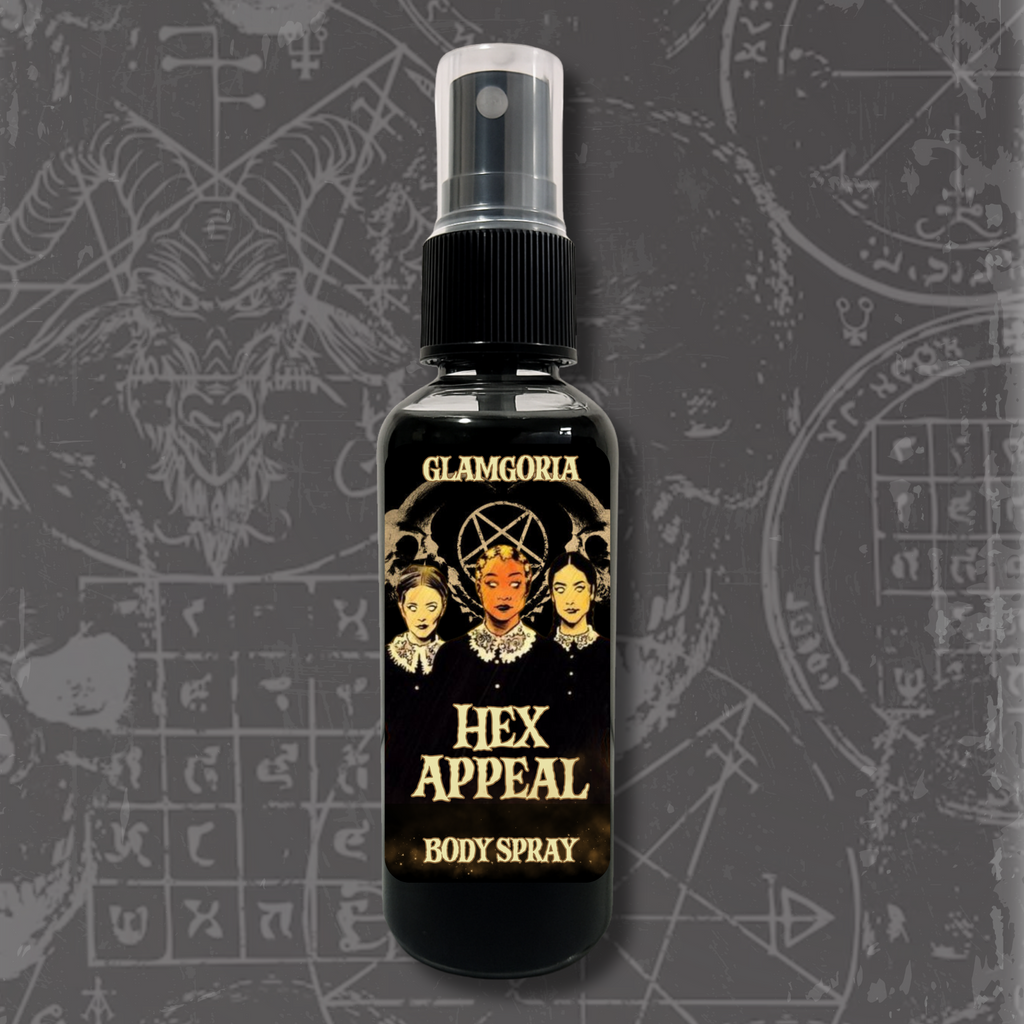A sleek black spray bottle labeled Hex Appeal Body Spray by Glamgoria. The design features the Weird Sisters-inspired artwork with occult motifs.