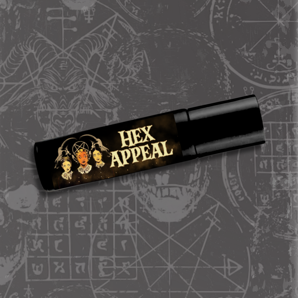 A slim black roller bottle labeled Hex Appeal, featuring witchy artwork and gold smoky accents.
