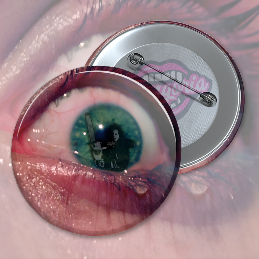 Horror pin featuring a close-up bloodshot eye reflecting a chainsaw-wielding figure inspired by The Texas Chain Saw Massacre