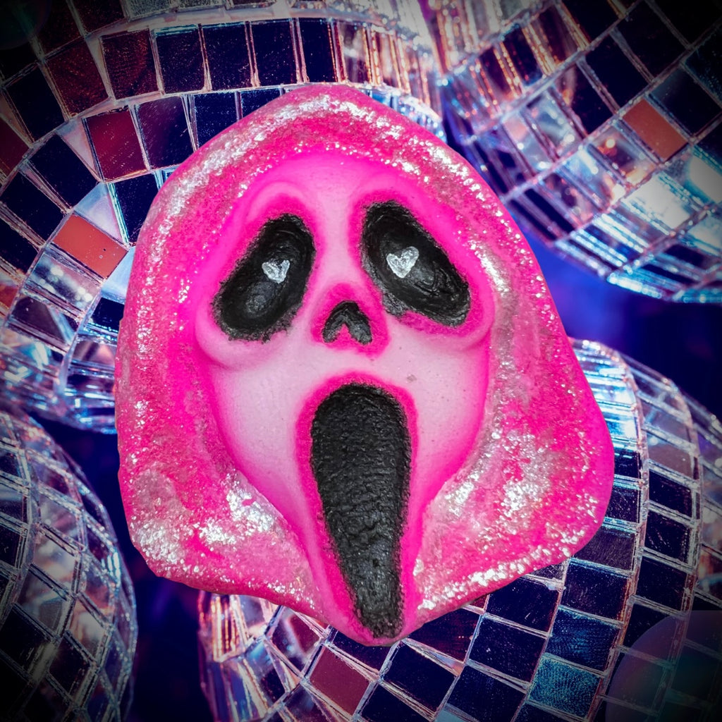 Pink Ghostface-inspired bath bomb with glittery shimmer, shaped like the Scream mask