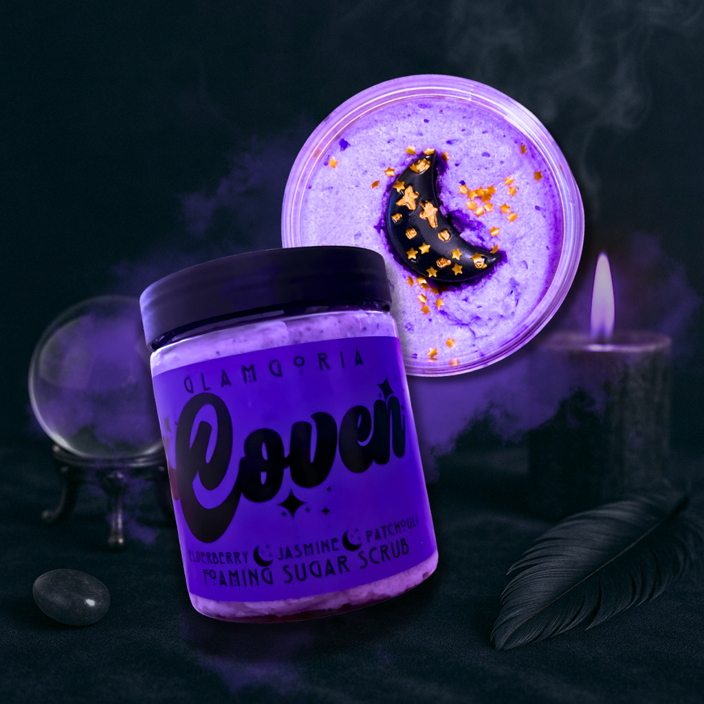 Coven foaming sugar scrub in a mystical flatlay with smoky, moody lighting.